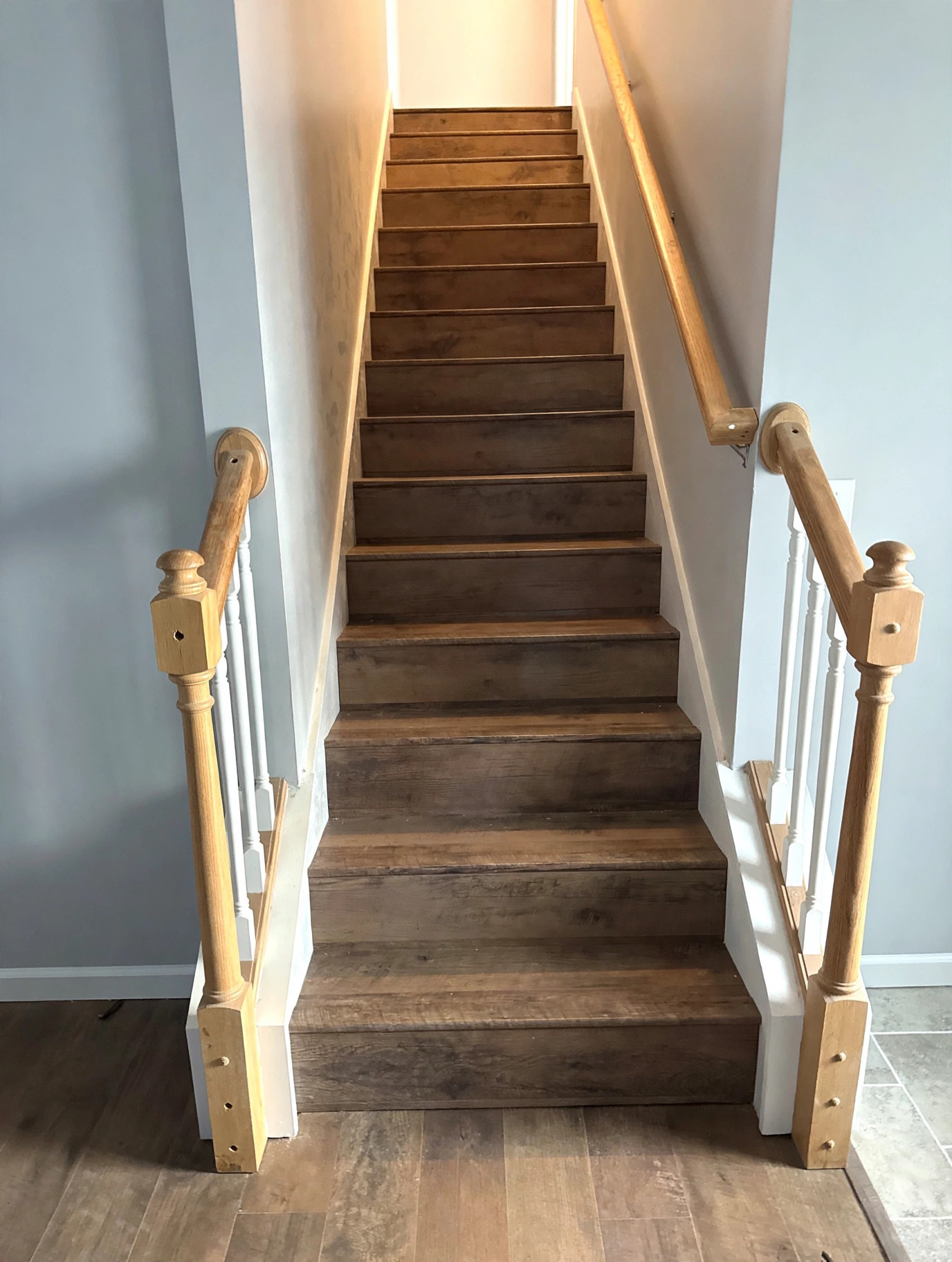 Finished staircase wrapped in matching luxury vinyl plank flooring