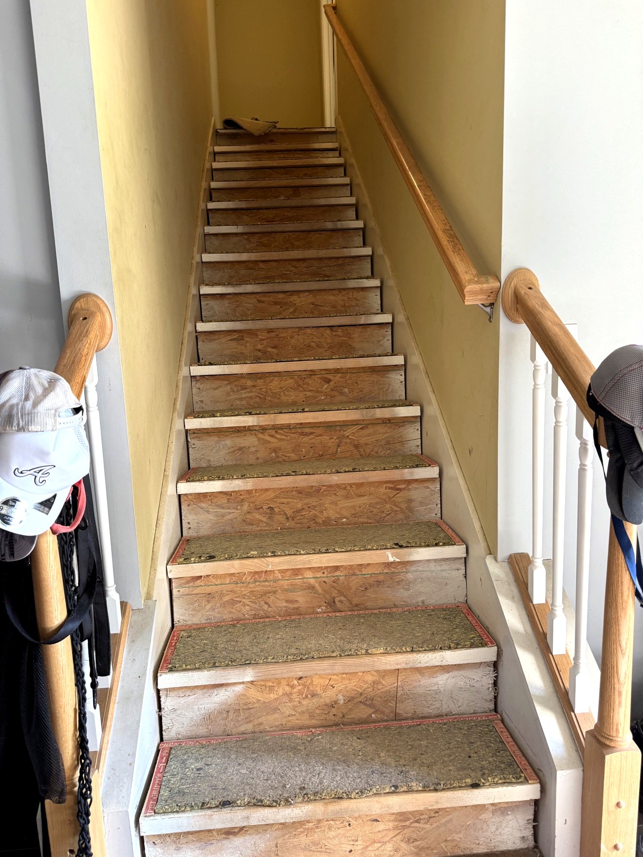 Staircase during tear-out with the old carpet pulled away